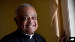 FILE - Washington D.C. Archbishop Wilton Gregory poses for a portrait following Mass at St. Augustine Church in Washington, June 2, 2019.
