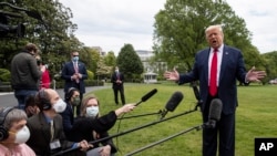 President Donald Trump speaks with reporters on the South Lawn of the White House, in Washington, May 14, 2020. 