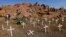 Members of South Africa's mining community walk near crosses placed at a hill known as the "Hill of Horror", where 43 miners died during clashes with police last year at Lonmin's Marikana platinum mine in Rustenburg, northwest of Johannesburg, May 14, 201