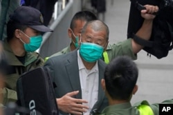 FILE - Democracy advocate Jimmy Lai leaves the Hong Kong's Court of Final Appeal, Feb. 9, 2021.