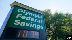 A display at an Olympia Federal Savings branch shows a temperature of 107 degrees Fahrenheit, Monday, June 28, 2021, in the early evening in Olympia, Wash.