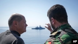 FILE - German Chancellor Olaf Scholz observes maneuvers in the Baltic Sea during his visit to the German Navy in Rostock-Warnemunde on June 5, 2023.