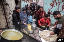Pengungsi Palestina mengantre untuk menerima makanan yang disumbangkan oleh organisasi amal menjelang buka puasa di Rafah di Jalur Gaza selatan pada 16 Maret 2024. (Foto: AFP)