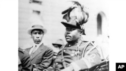 FILE - In this Aug. 1922 photo, Marcus Garvey is shown in a military uniform as the "Provisional President of Africa" during a parade on the opening day of the annual Convention of the Negro Peoples of the World in Harlem borough of New York. 