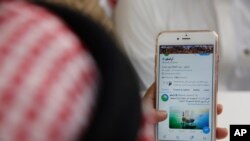  A man reads Aramco's twitter page at a coffee shop in Jiddah, Saudi Arabia, Nov. 3, 2019. 
