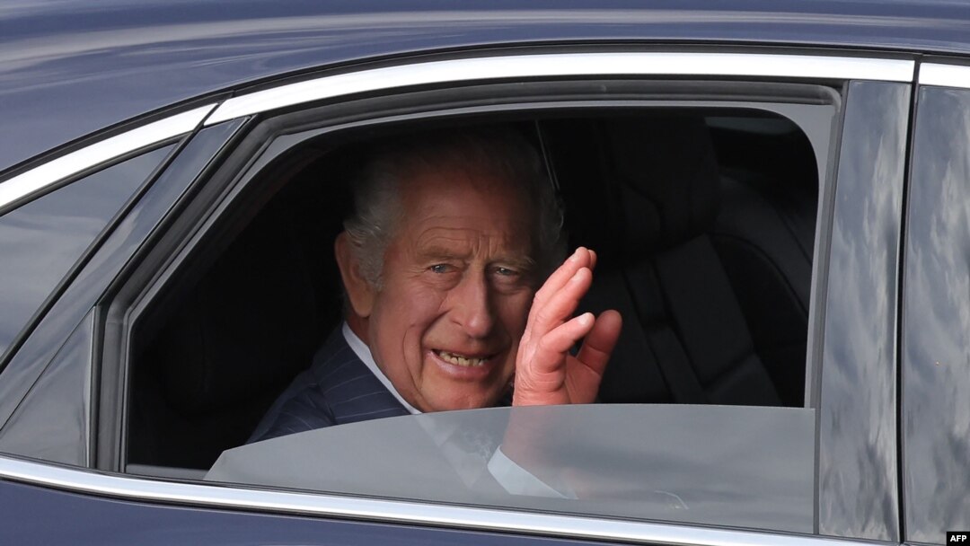 FILE — Britain's King Charles III waves from a car during a procession down the Champs-Elysees Avenue in Paris on September 20, 2023.