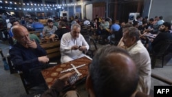 Iraqis sit at a popular café in the old city of Mosul on Sept. 2, 2024, seven years after the Islamist State (IS) group was ousted from the northern Iraqi city.