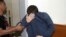 FILE - A 19-year-old dual U.S.-Israeli citizen covers his face as he is brought to court in Rishon Lezion, Israel, March 23, 2017. 