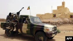 FILE - Malian soldiers patrol in Kidal, northern Mali, July 29, 2013. Mali's army and Russian mercenaries are accused of killing civilians during a military operation in June 2024 in the Kidal region. The Malian military says it has no knowledge of the alleged killings.