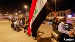 Iraqi protesters demonstrate against Iraq's parliament after it approved amendments to the elections law, in Najaf, Iraq March 27, 2023. 