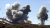 FILE - This undated photo released by the Army Times March 5, 2002, shows smoke rising from Taliban and al-Qaida positions in the hills of Sirkankel, Afghanistan, after heavy U.S. bombing.
