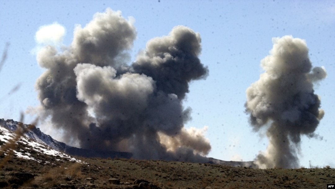 FILE - This undated photo released by the Army Times March 5, 2002, shows smoke rising from Taliban and al-Qaida positions in the hills of Sirkankel, Afghanistan, after heavy U.S. bombing.
