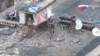 A drone view shows Russian service members waving flags on the roof of a building in the settlement of Velyka Novosilka in the Donetsk region, a Russian-controlled part of Ukraine, in this still image from video released Jan. 26, 2025. Russian Defense Ministry/Handout