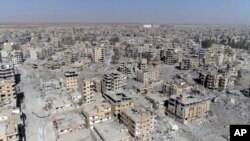 This Thursday, Oct. 19, 2017 frame grab made from drone video shows damaged buildings in Raqqa, Syria two days after Syrian Democratic Forces said that military operations to oust the Islamic State group have ended and that their fighters have taken full control of the city.
