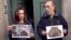 Forensic expert Francisco Etxeberria (R) and archaeologist Almudena Garcia Rubio hold pictures showing the remains of niches, one of them appeared with the letters M.C. on it, found in the crypt of Trinitarian convent as they pose outside the convent in M