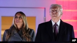 President-elect Donald Trump and Melania Trump watch fireworks at Trump National Golf Club in Sterling, Va., Jan. 18, 2025, ahead of the 60th Presidential Inauguration.