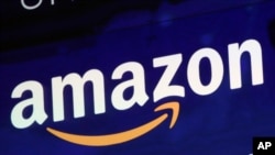 FILE - The Amazon logo is displayed on a screen at the Nasdaq MarketSite in New York, July 27, 2018.