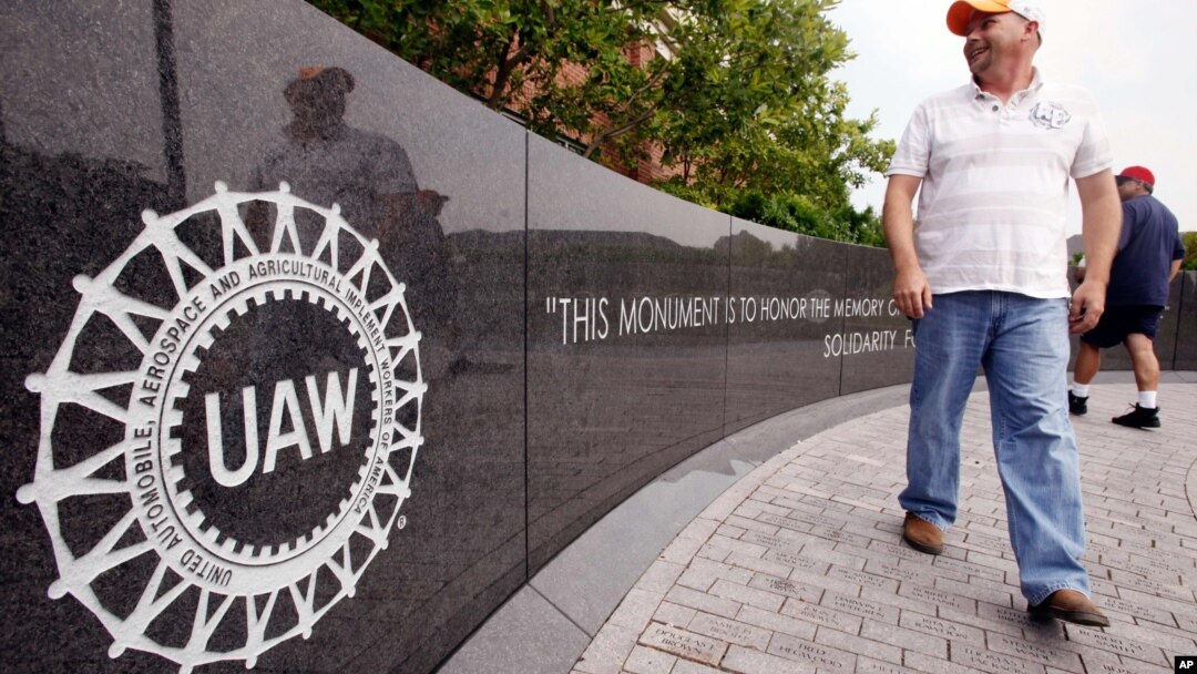 FILE - Autoworker Brent Watts walks to the United Auto Workers union hall in Spring, Hill, Tennessee.