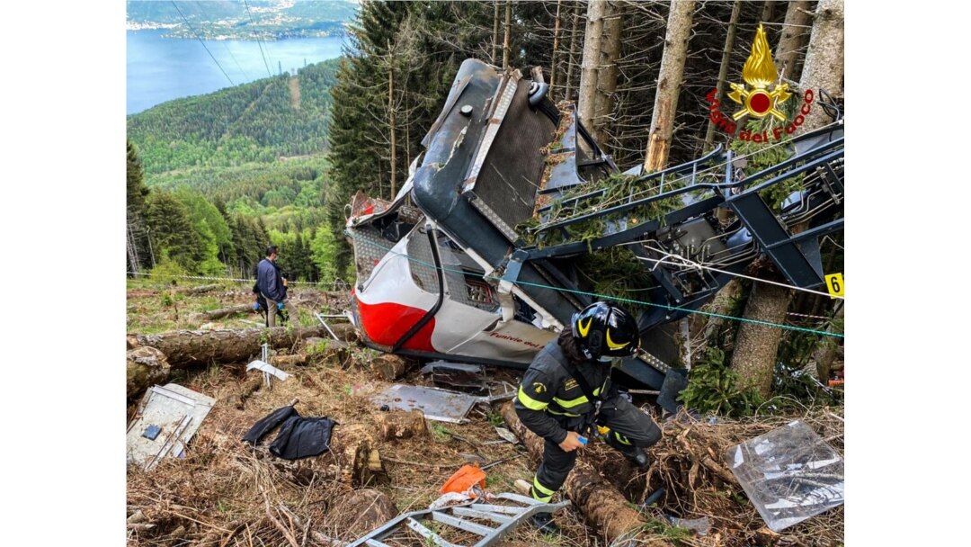 A photo taken and handed out May 23, 2021, by the Italian Firefighters "Vigili del Fuoco" shows rescuers by a cable car that crashed to the ground in the resort town of Stresa on the shores of Lake Maggiore in the Piedmont region.