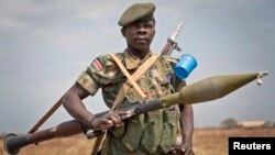 FILE - A South Sudanese government soldier stands guard in Malakal, Upper Nile State, South Sudan. 