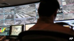 FILE - A security officer monitors Muslim pilgrims attending the annual hajj pilgrimage on CCTV screens at a security command center in Mina, Saudi Arabia, a day after a stampede killed more than 700 people, Sept. 25 2015. 