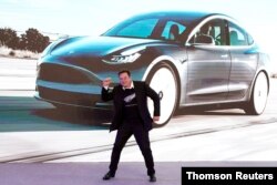 FILE PHOTO: Tesla Inc CEO Elon Musk dances onstage during a delivery event for Tesla China-made Model 3 cars in Shanghai