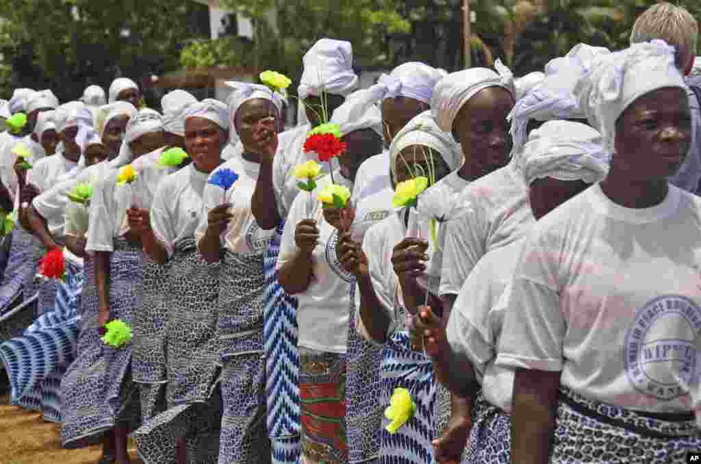 Liberia women walk together after praying for help with the Ebola virus, in Monrovia, Liberia. Aug. 14, 2014.