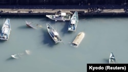 An aerial view shows capsized boats believed to be affected by the tsunami caused by an underwater volcano eruption on the island of Tonga at the South Pacific, in Muroto, Kochi prefecture, Japan, in this photo taken by Kyodo January 16, 2022. 