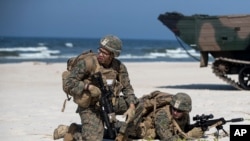 FILE - U.S. Marines take part in a landing operation during military Exercise Baltops 2018 at the Baltic Sea, about 340 kms (211 miles) west north of the capital Vilnius, Lithuania, June 4, 2018.