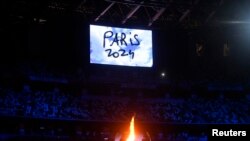FILE: Olympic Stadium, Tokyo, Japan - August 8, 2021. The Olympic torch and cauldron are seen with Paris 2024 displayed on the big screen during the closing ceremony.