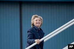 Democratic presidential candidate Hillary Clinton boards her campaign plane in White Plains, N.Y., Oct. 4, 2016.