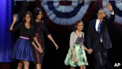President Barack Obama waves as he walks on stage with first lady Michelle Obama and daughters Malia and Sasha at his election night party November 7, 2012, in Chicago, Illinois.