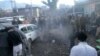 Pakistani security officals and local residents are seen gathered at the site of a bomb explosion at a market in Parachinar city, the capital of Kurram tribal district on the Afghan border on Jan. 21, 2017.