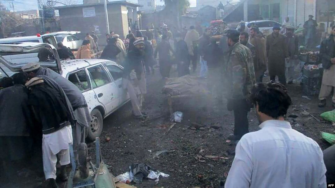 Pejabat keamanan Pakistan dan warga setempat terlihat berkumpul di lokasi ledakan bom di sebuah pasar di kota Parachinar, ibukota distrik suku Kurram di perbatasan Afghanistan, 21 Januari 2017.(AFP Photo).