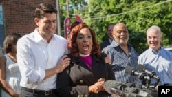 House Speaker Paul Ryan, R-Wis., listens at left as Bishop Shirley Holloway of the House of Help City of Hope speaks during a news conference in the Washington neighborhood of Anacostia, where Ryan proposed an overhaul of U.S. poverty programs, June 7, 2016.