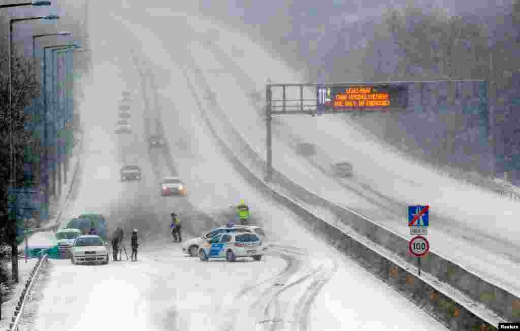 Police block the traffic at M1-M7 highway outside of Budapest, as heavy snow hits Hungary.