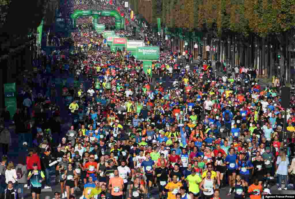 Runners compete on the Champs-Elysees avenue in the 42,195 km Paris Marathon, in France, as part of its 45th edition.