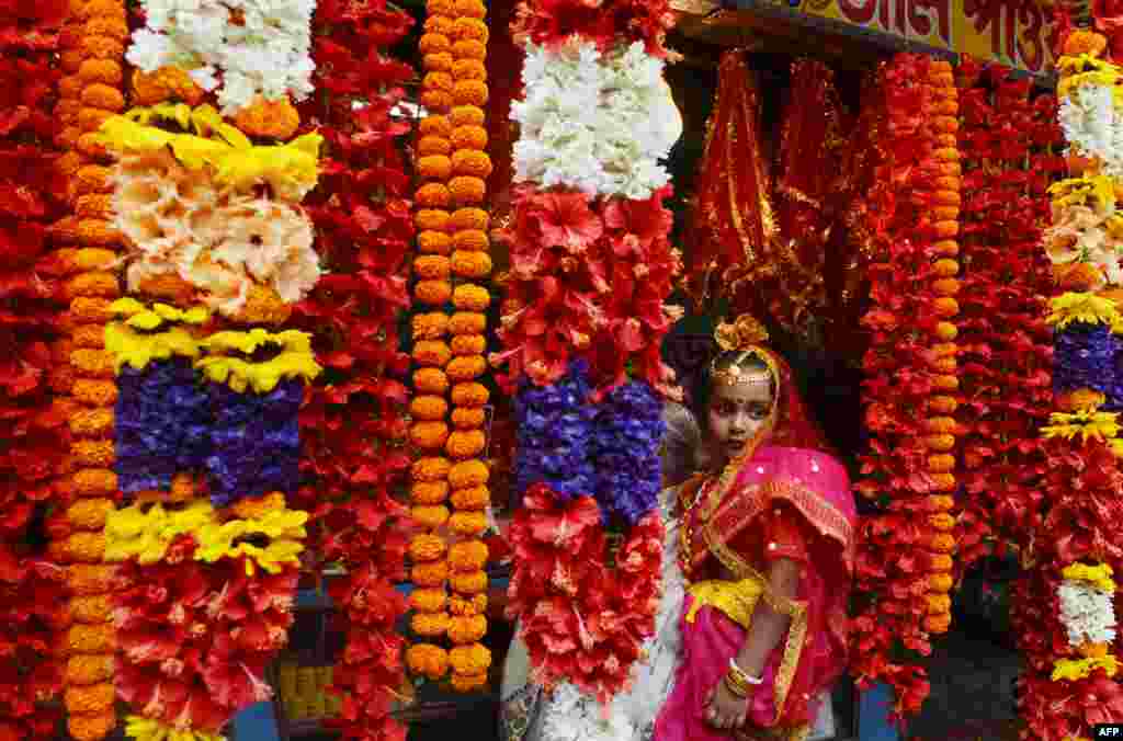 A Hindu girl arrives to take part in the Kumari Puja at the Adyapeath Ashram on the outskirts of Kolkata, India.