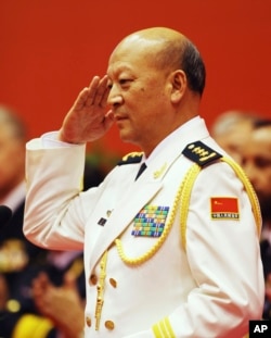 FILE - China Navy Commander Adm. Wu Shengli salutes after he made a speech duirng an opening ceremony to mark the 60th anniversary of the founding of the Chinese People's Liberation Army (PLA) Navy at Qingdao Port.