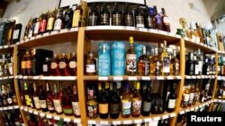 FILE - Bottles of single malt Scotch whisky are pictured in a shop near Lausanne, Switzerland, May 18, 2017. The U.S. agreed Thursday to suspend for four months tariffs it imposed on British goods such as Scotch whisky.