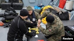 FILE - Navy divers from the 12th Minesweeper Squadron of the 8th Coastal Defense Flotilla take part in an operation to defuse the largest unexploded World War II Tallboy bomb ever found in Poland, in Swinoujscie, Oct. 12, 2020. 