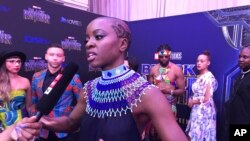 Danai Gurira berbicara sebagai salah satu pemeran di film “Black Panther,” tiba di penayangan perdana di Afrika Selatan, 16 Februari 2018, di Johannesburg.