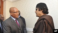 South Africa's President Jacob Zuma (C) greets Libyan leader Moammar Gadhafi (R) before their meeting in Tripoli in this handout picture taken May 30, 2011