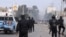 Police forces face protesters in the city of Ennour, near Kasserine, Tunisia, Wednesday, Jan. 20, 2016. Tunisia imposed a nationwide overnight curfew Friday in response to growing unrest as protests over unemployment across the country descended into violence in some cities.