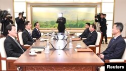 The head of North Korean delegation Jon Jong Su talks with his South Korean counterpart Chun Hae-sung during their meeting at the truce village of Panmunjom in the demilitarized zone separating the two Koreas, Jan. 17, 2018.