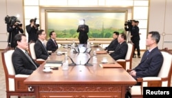 Head of North Korean delegation Jon Jong Su talks with his South Korean counterpart Chun Hae-sung during their meeting at the truce village of Panmunjom in the demilitarized zone separating the two Koreas, South Korea, Jan. 17, 2018.