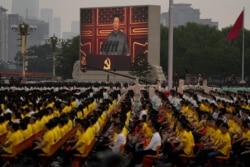 A screen shows Chinese President Xi Jinping speak during a ceremony to mark the 100th anniversary of the founding of the ruling Chinese Communist Party at Tiananmen Square in Beijing, July 1, 2021.