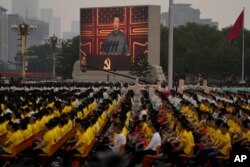 A screen shows Chinese President Xi Jinping speak during a ceremony to mark the 100th anniversary of the founding of the ruling Chinese Communist Party at Tiananmen Square in Beijing Thursday, July 1, 2021. (AP Photo/Ng Han Guan)