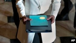 FILE - Clerk of the House Cheryl Johnson carries the articles of impeachment against President Donald Trump to the Senate on Capitol Hill in Washington. 