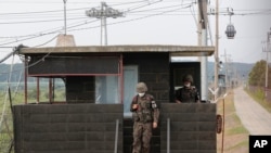 South Korean army soldiers step down from their military guard post in Paju, South Korea, near the border with North Korea, June 17, 2020. 